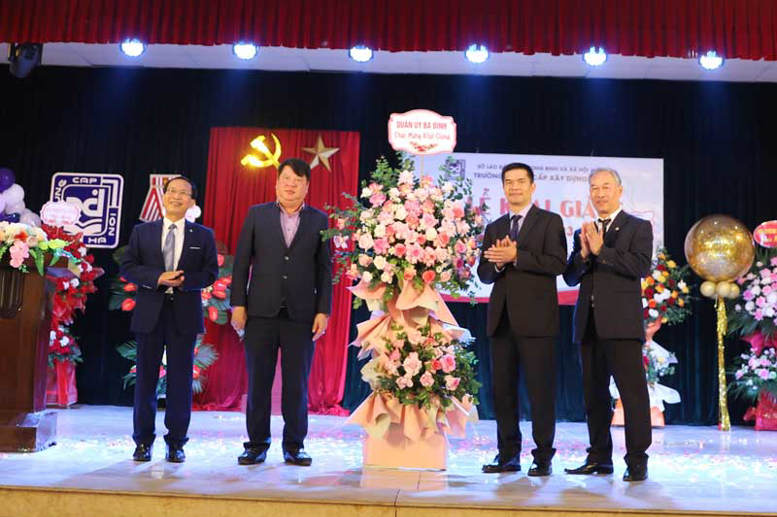 Đại diện lãnh đạo Quận ủy - UBND quận Ba Đình chúc mừng và tặng hoa nhà trường